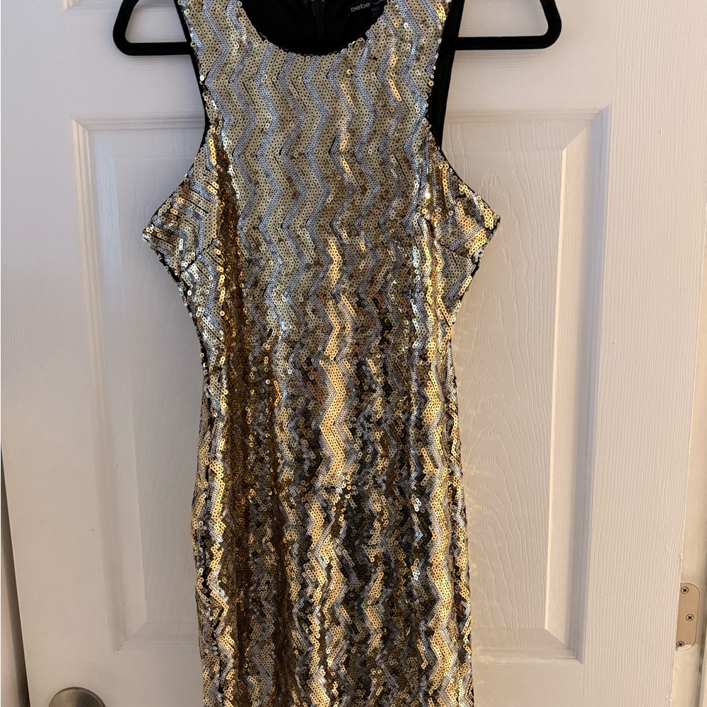 BÉBÉ Elegant Gold and Black Sequin Mini Dress with cold-shoulder cutouts. SL